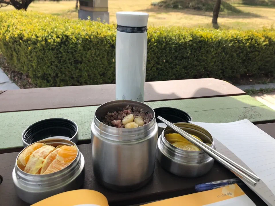 Containers with porridge, fruit and lemon on a table